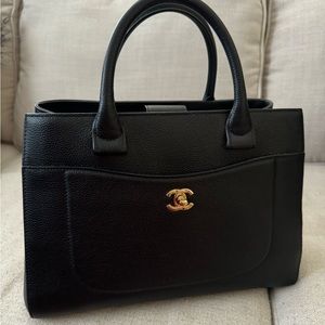 Chanel Neo tote in black caviar and gold hardware.